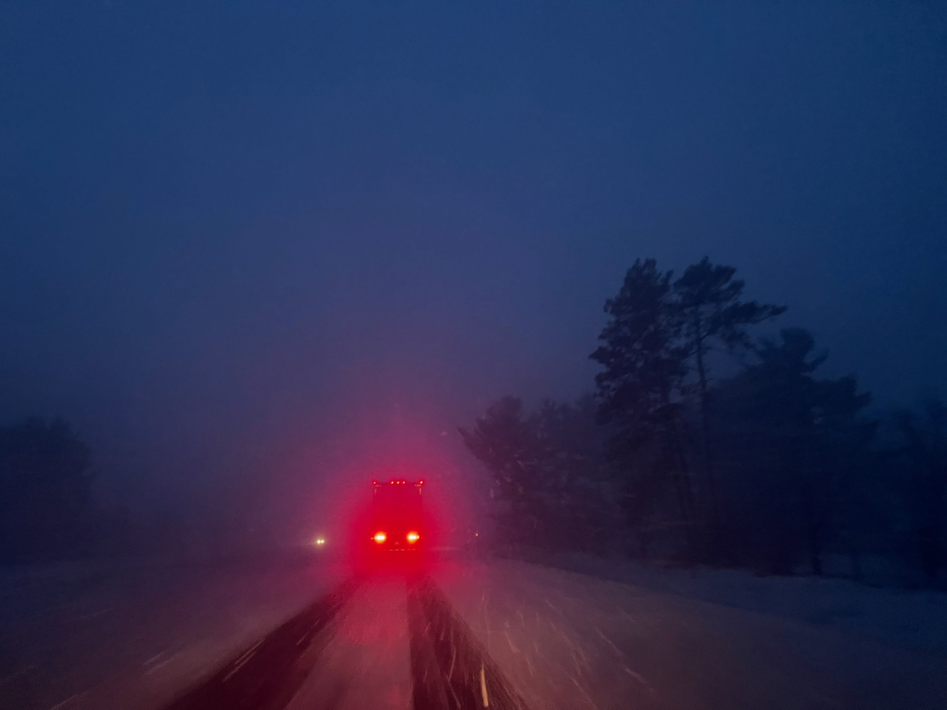 Red light disappearing into blue fog